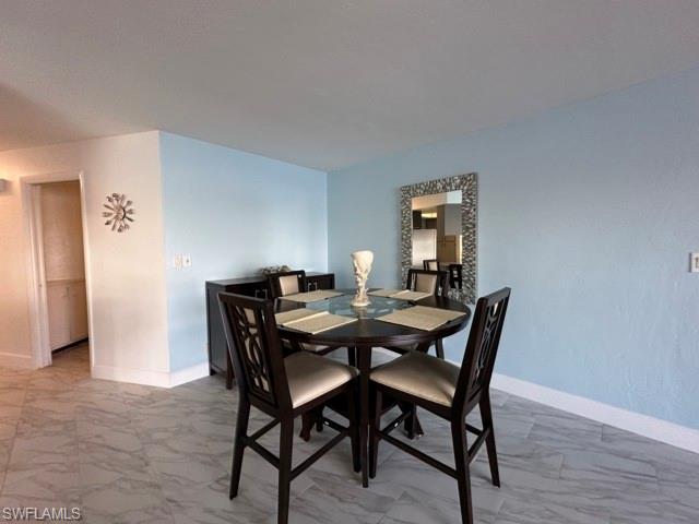 3065 50th Lane Southwest Naples, FL 34116 - Photo 11 of 21 a view of a dining room with furniture and wooden floor