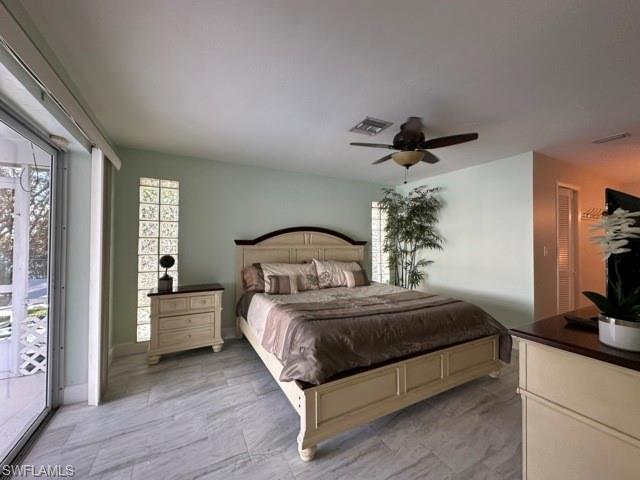 3065 50th Lane Southwest Naples, FL 34116 - Photo 14 of 21 a bedroom with a bed and a chandelier