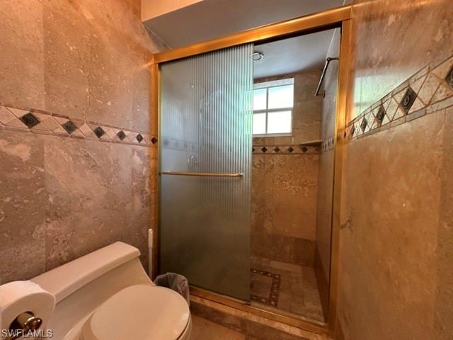 3065 50th Lane Southwest Naples, FL 34116 - Photo 17 of 21 a bathroom with a toilet and shower