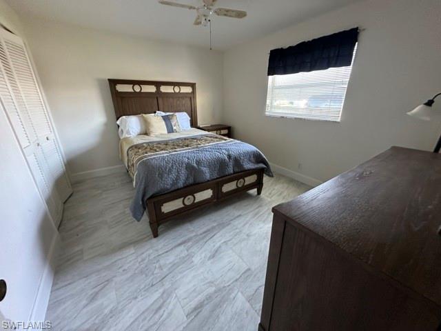 3065 50th Lane Southwest Naples, FL 34116 - Photo 18 of 21 a bedroom with a bed and a chandelier