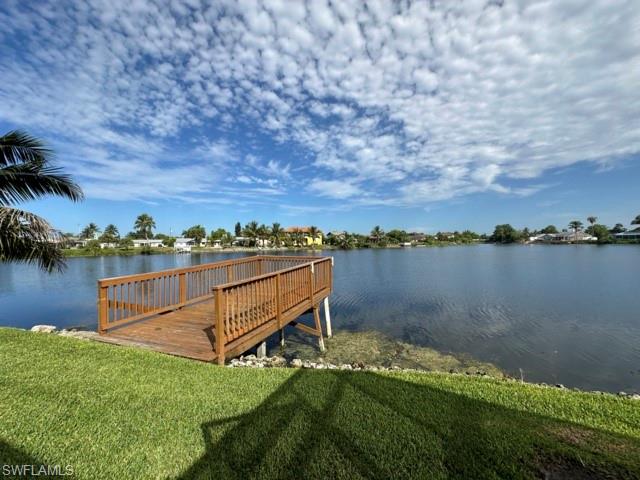 3065 50th Lane Southwest Naples, FL 34116 - Photo 2 of 21 a view of a lake with houses in the back