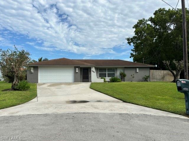 3065 50th Lane Southwest Naples, FL 34116 - Photo 6 of 21 a front view of a house with a yard and garage