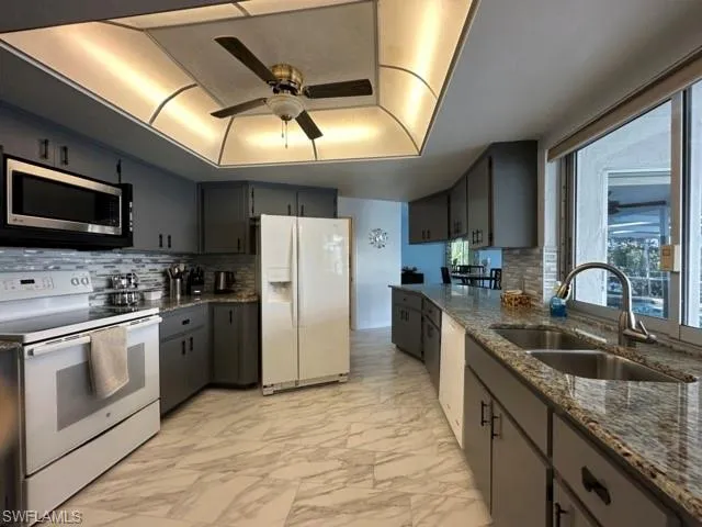 a kitchen with refrigerator cabinets and a sink