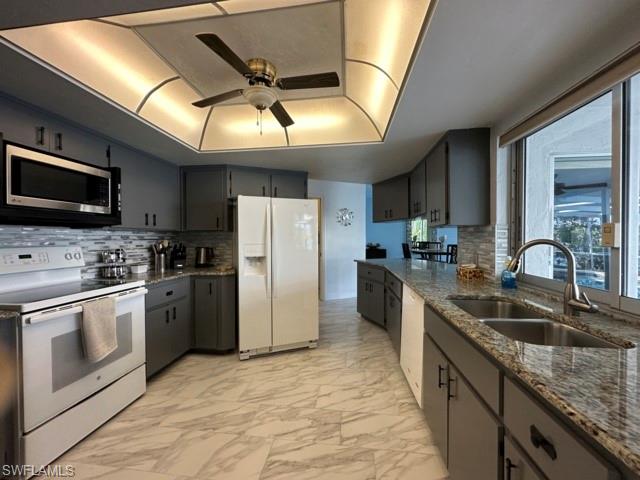 3065 50th Lane Southwest Naples, FL 34116 - Photo 8 of 21 a kitchen with refrigerator cabinets and a sink