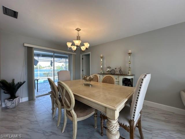 3065 50th Lane Southwest Naples, FL 34116 - Photo 9 of 21 a view of a dining room with furniture wooden floor and chandelier