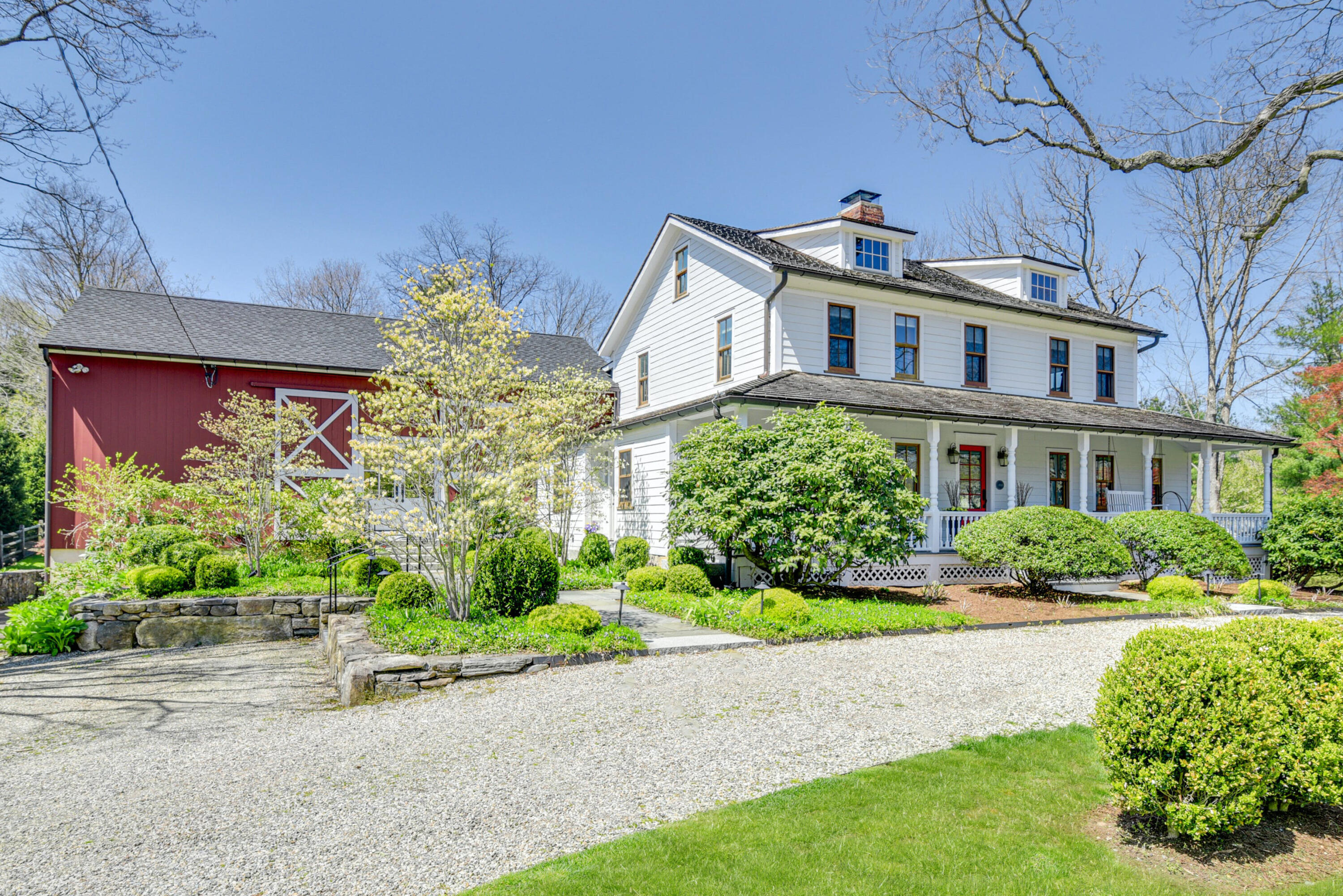 51 White Oak Shade Road New Canaan, CT 06840 - Photo 1 of 40 a front view of a house with a yard and potted plants