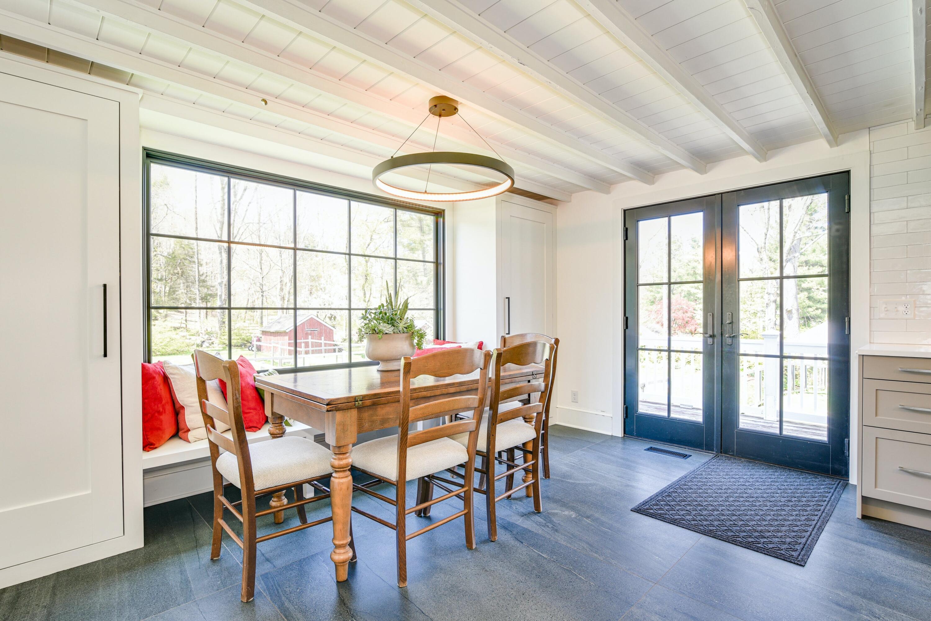 51 White Oak Shade Road New Canaan, CT 06840 - Photo 13 of 40 a view of a dining room with furniture and wooden floor