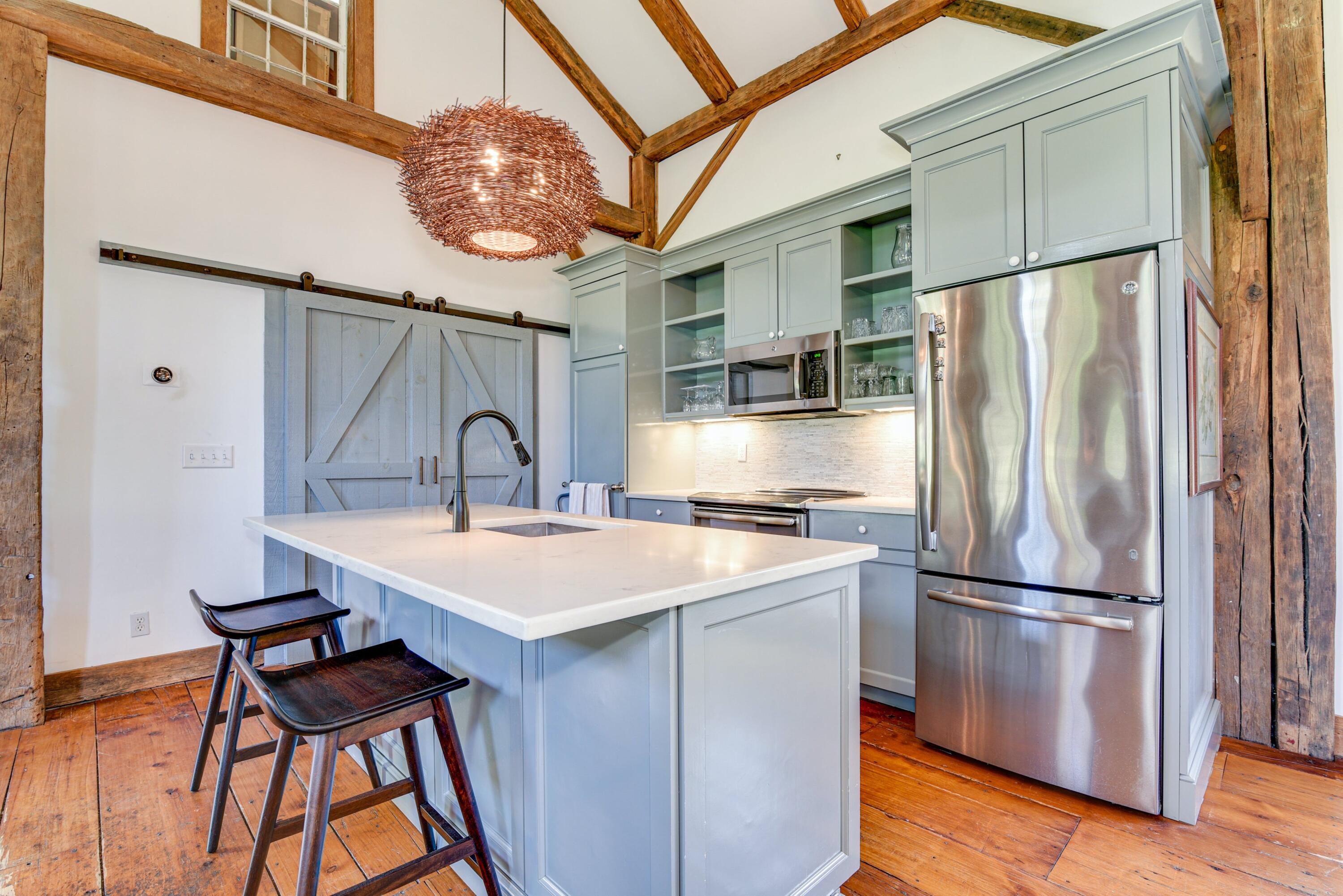 51 White Oak Shade Road New Canaan, CT 06840 - Photo 17 of 40 a kitchen with stainless steel appliances granite countertop a refrigerator a sink a stove and a dining table