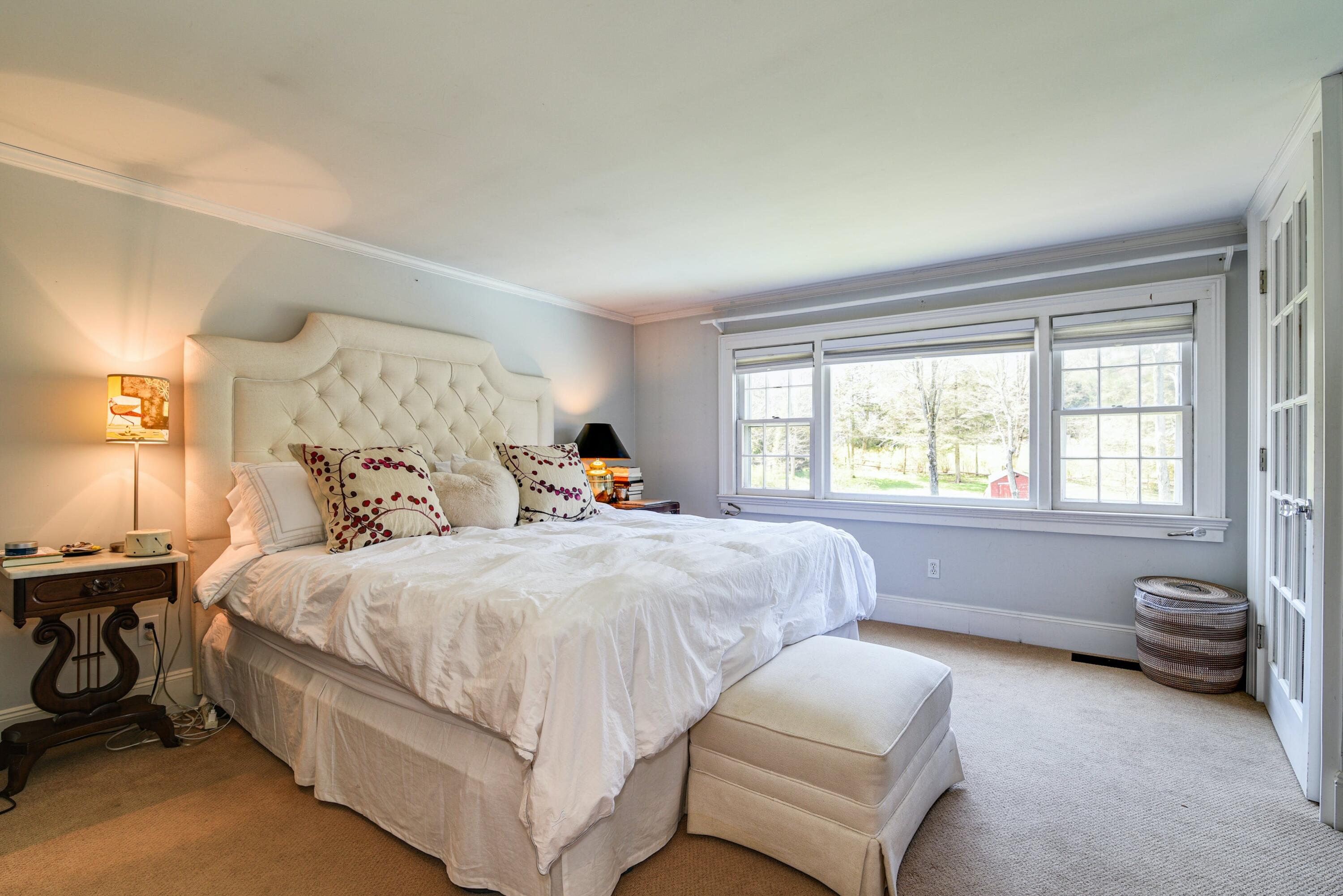 51 White Oak Shade Road New Canaan, CT 06840 - Photo 25 of 40 a bedroom with a bed and a couch
