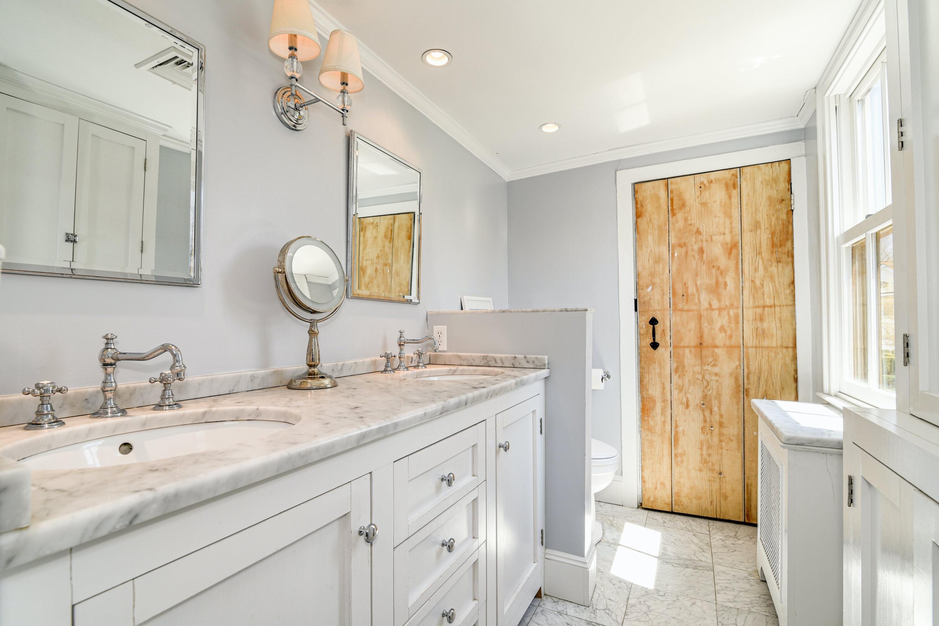 51 White Oak Shade Road New Canaan, CT 06840 - Photo 27 of 40 a bathroom with a granite countertop sink and a mirror