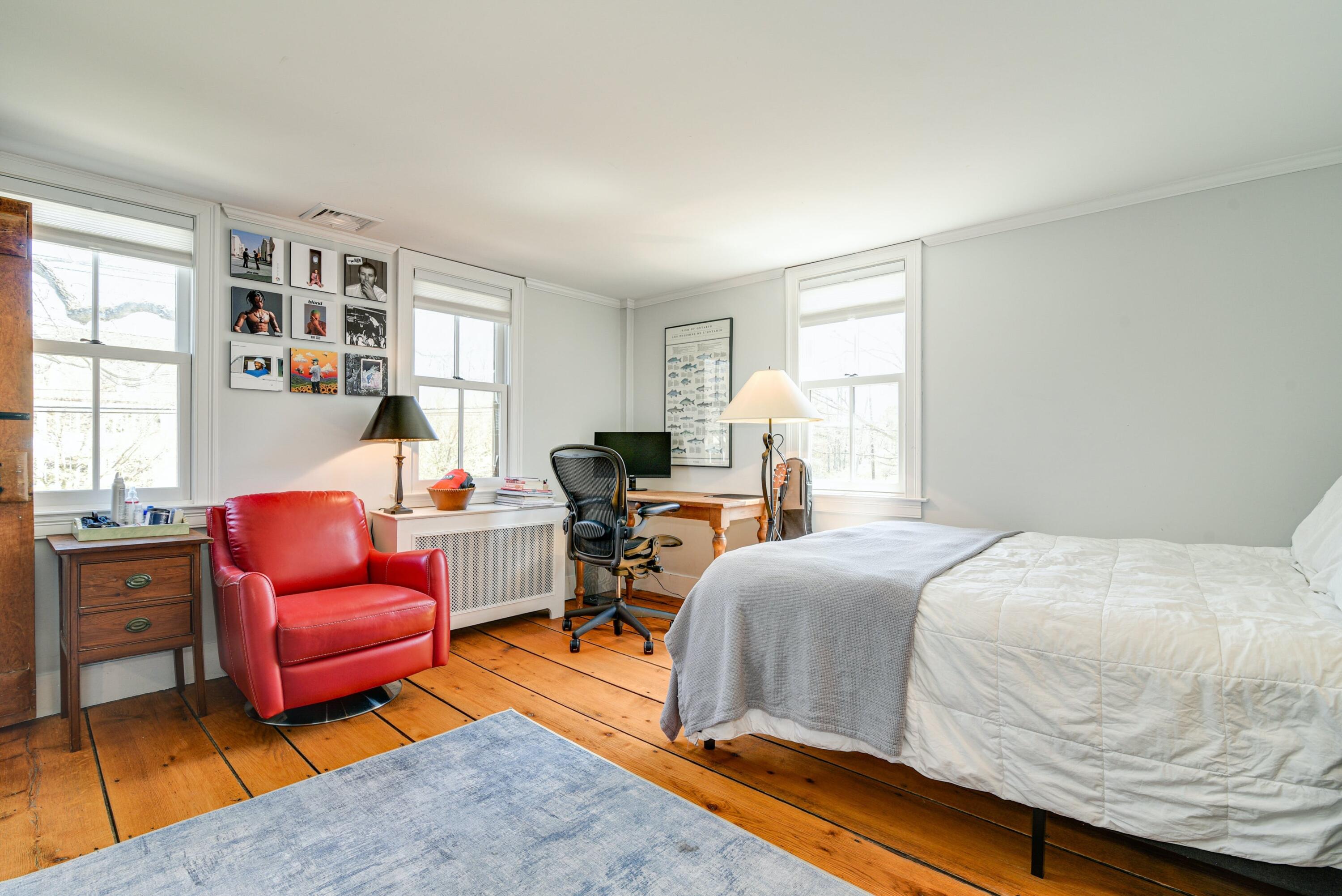 51 White Oak Shade Road New Canaan, CT 06840 - Photo 28 of 40 a bedroom with a bed and wooden floor