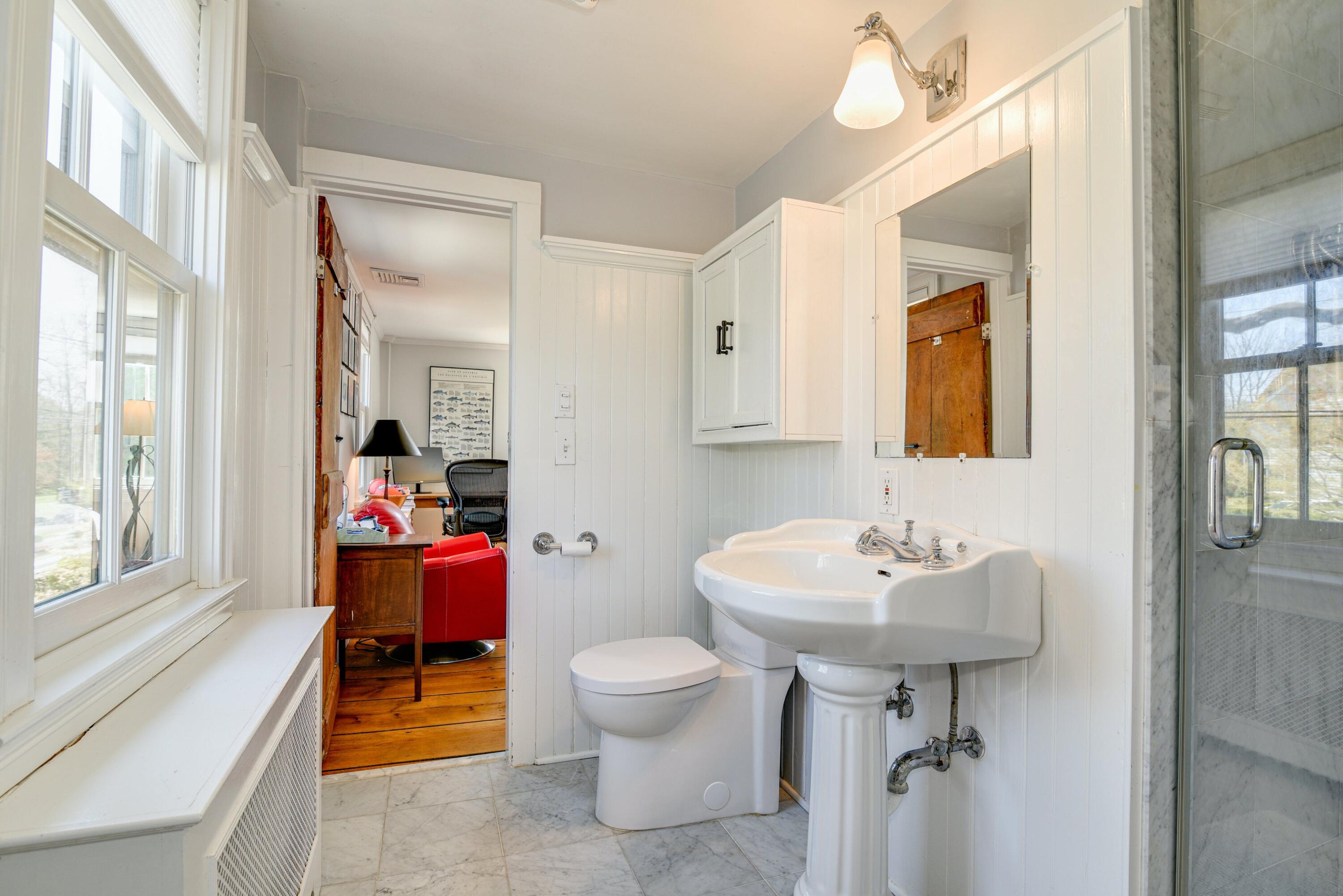 51 White Oak Shade Road New Canaan, CT 06840 - Photo 29 of 40 a bathroom with a sink toilet and a mirror