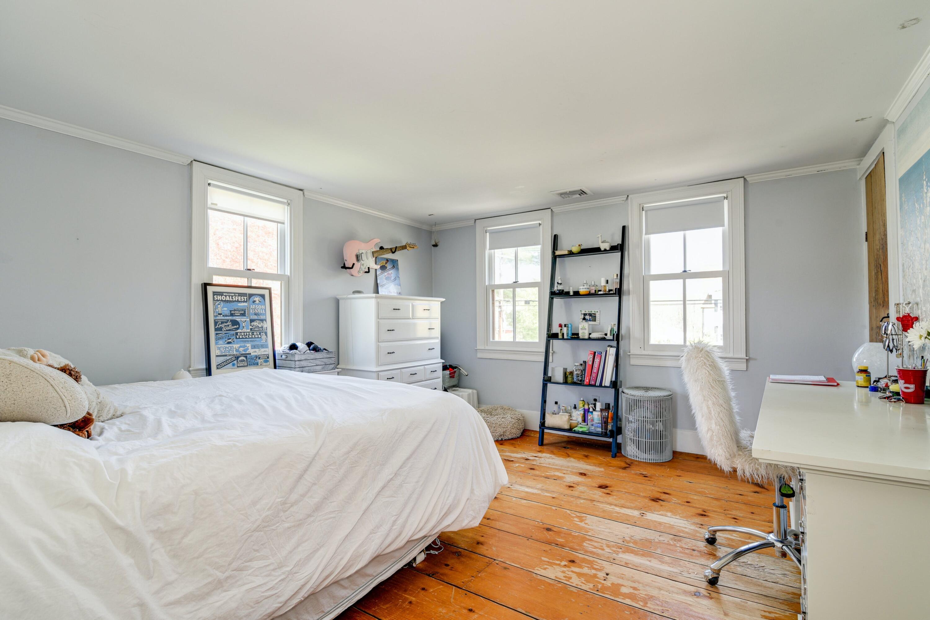 51 White Oak Shade Road New Canaan, CT 06840 - Photo 30 of 40 a bedroom with a bed and wooden floor