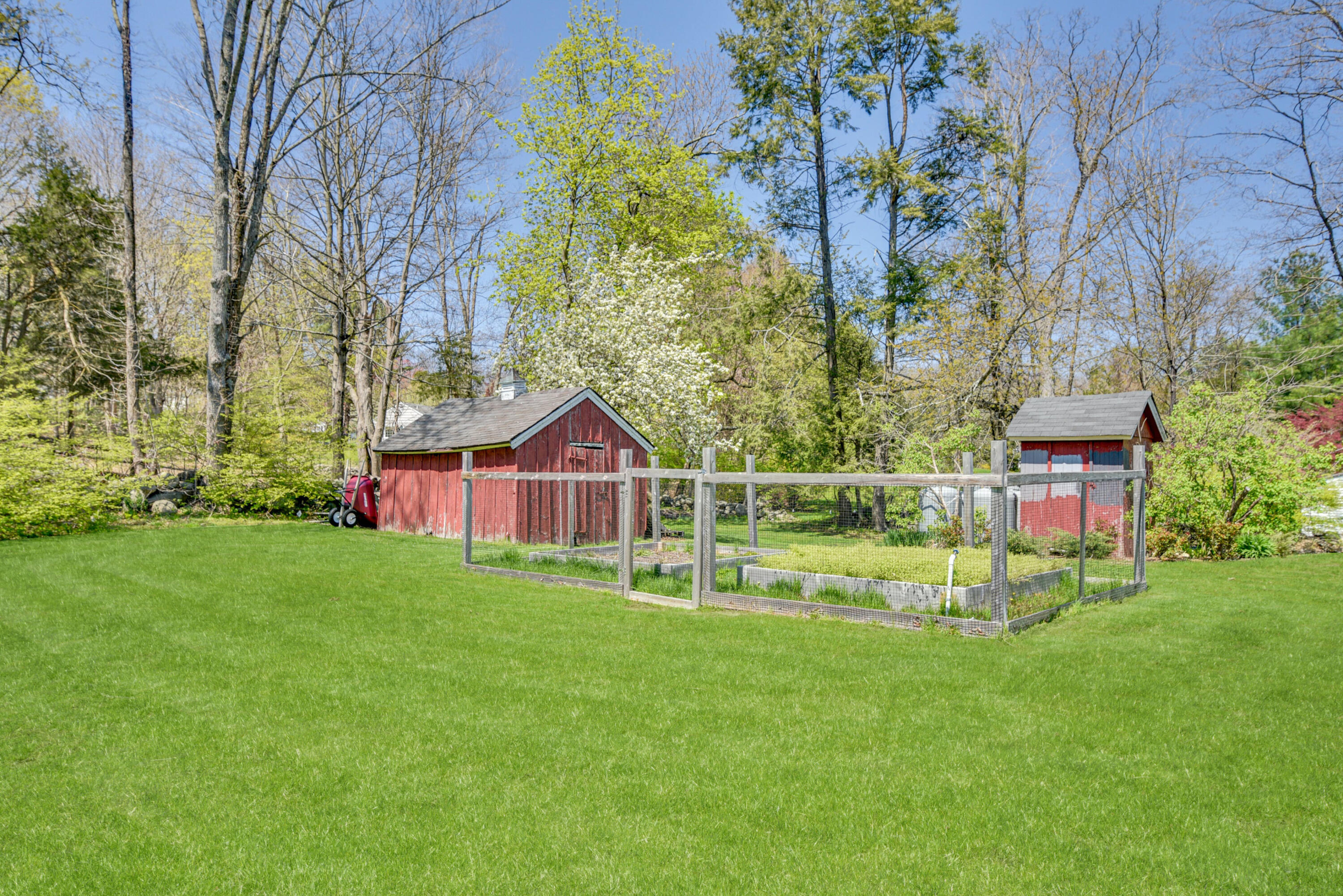 51 White Oak Shade Road New Canaan, CT 06840 - Photo 36 of 40 a front view of a house with a yard table and chairs