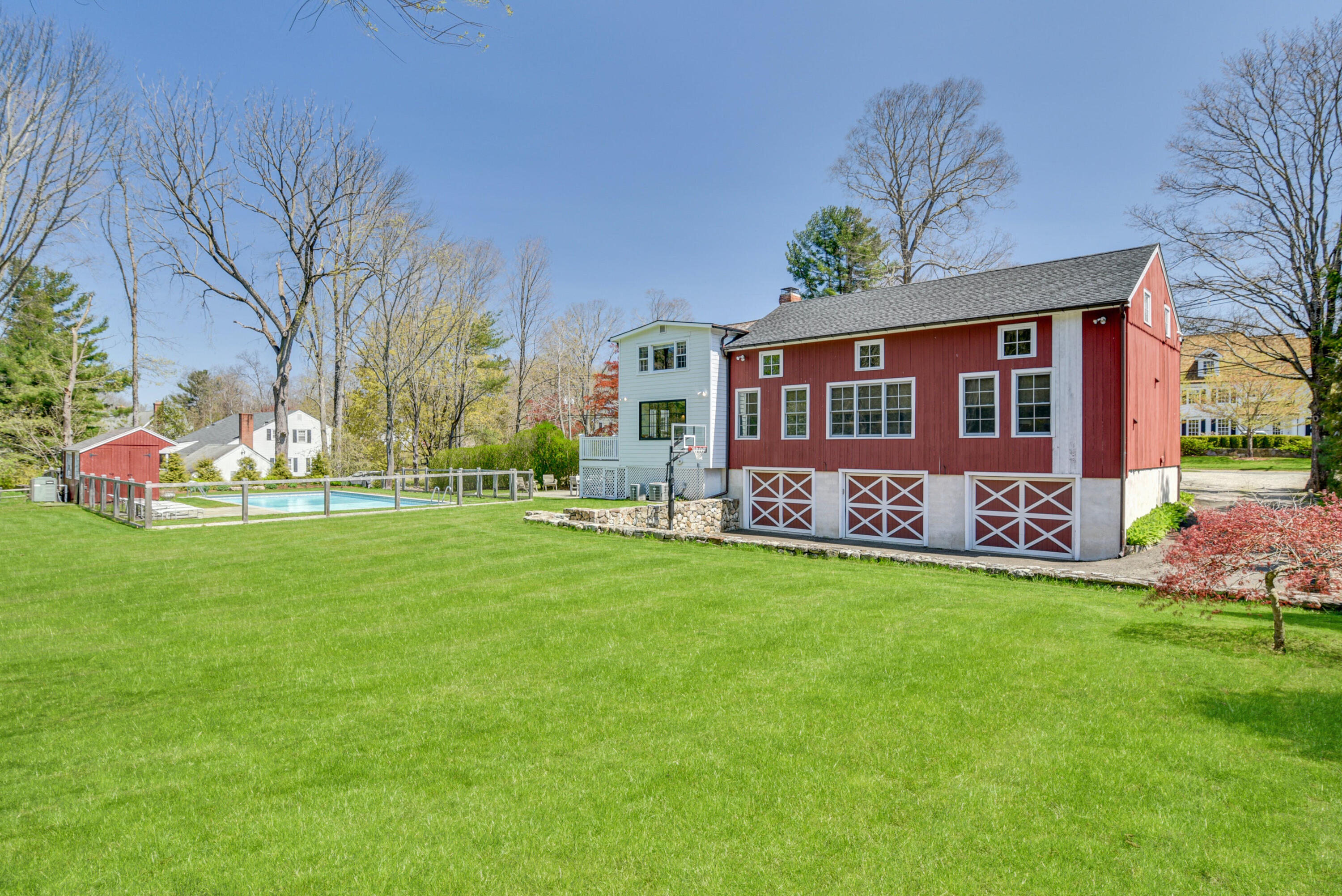 51 White Oak Shade Road New Canaan, CT 06840 - Photo 37 of 40 a front view of a house with a garden