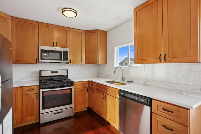a kitchen with a sink stove and microwave