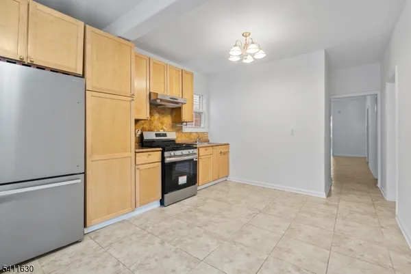 a kitchen with a refrigerator a stove a microwave and cabinets