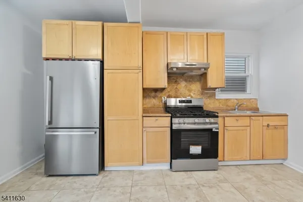 a kitchen with a stove and a refrigerator