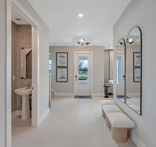 a living room with furniture and large windows