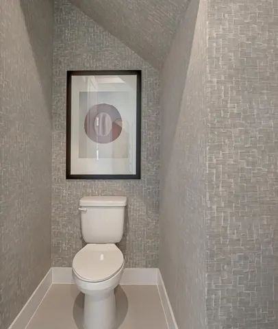 a living room with furniture potted plant and a large window