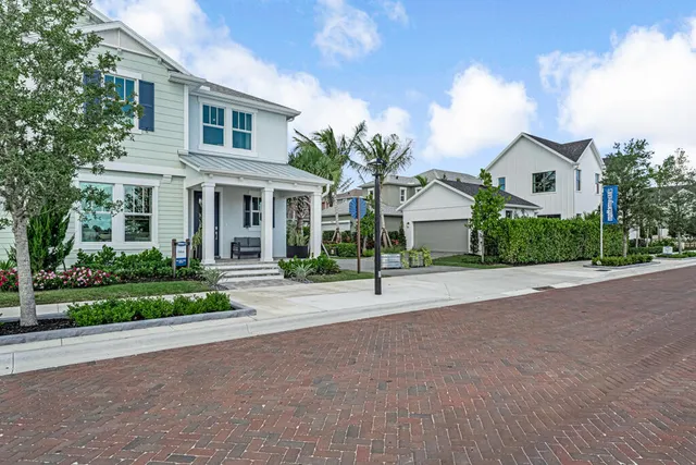 a front view of a house with a yard and a garage