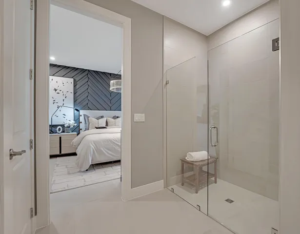 a room with a bed window and a table in it