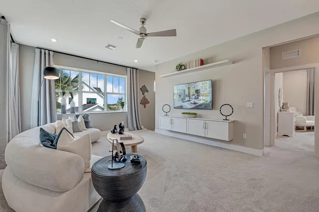 a front view of a house with a yard and potted plants