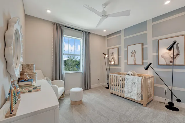 an aerial view of a house with a yard and a large tree