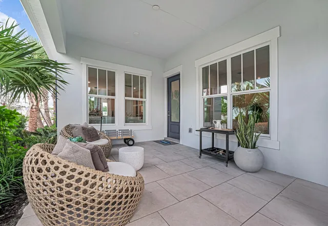 a view of a brick house with a yard and plants