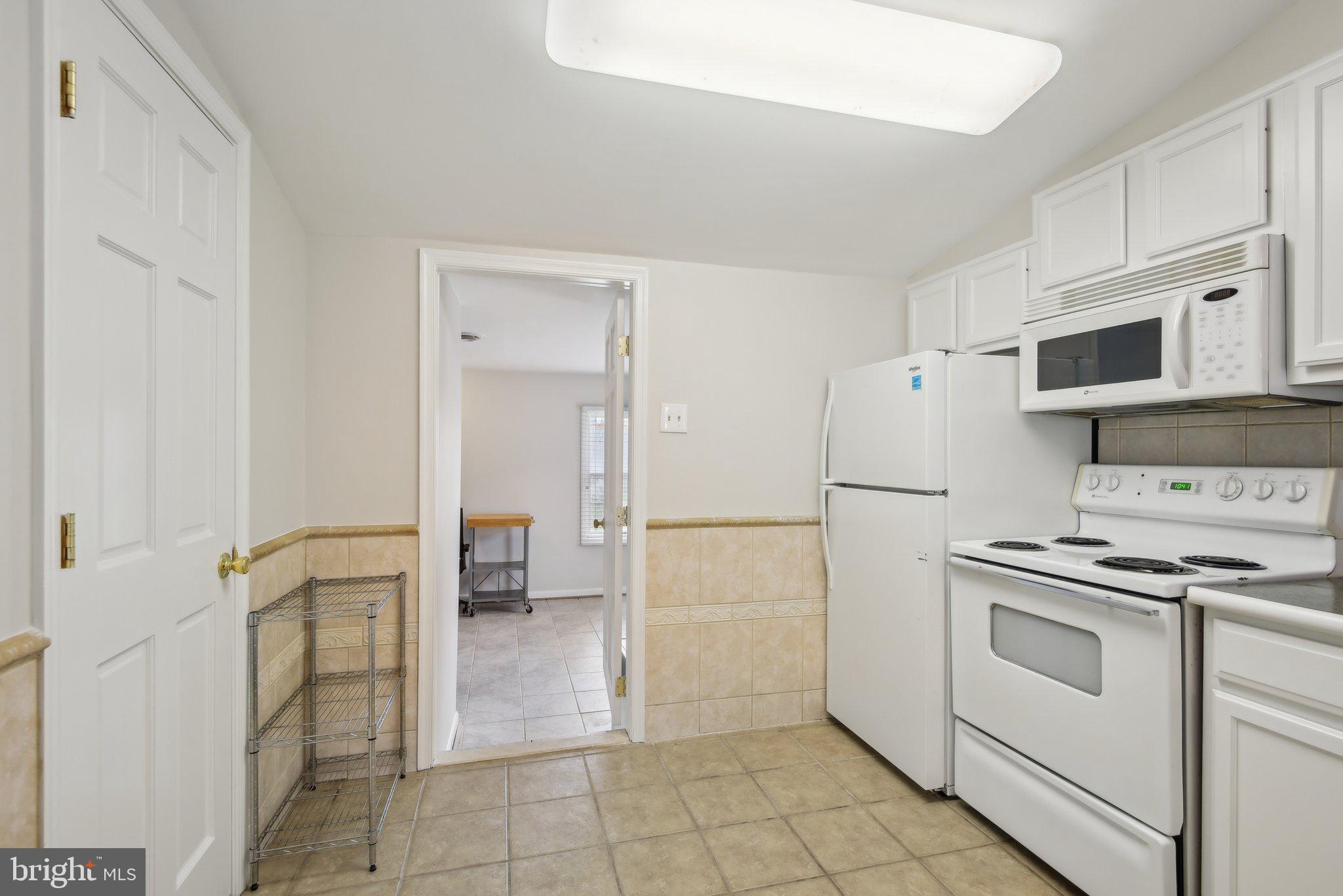 1813 Keymar Road Edgewater, MD 21037 - Photo 14 of 38 a kitchen with a stove a sink and a refrigerator