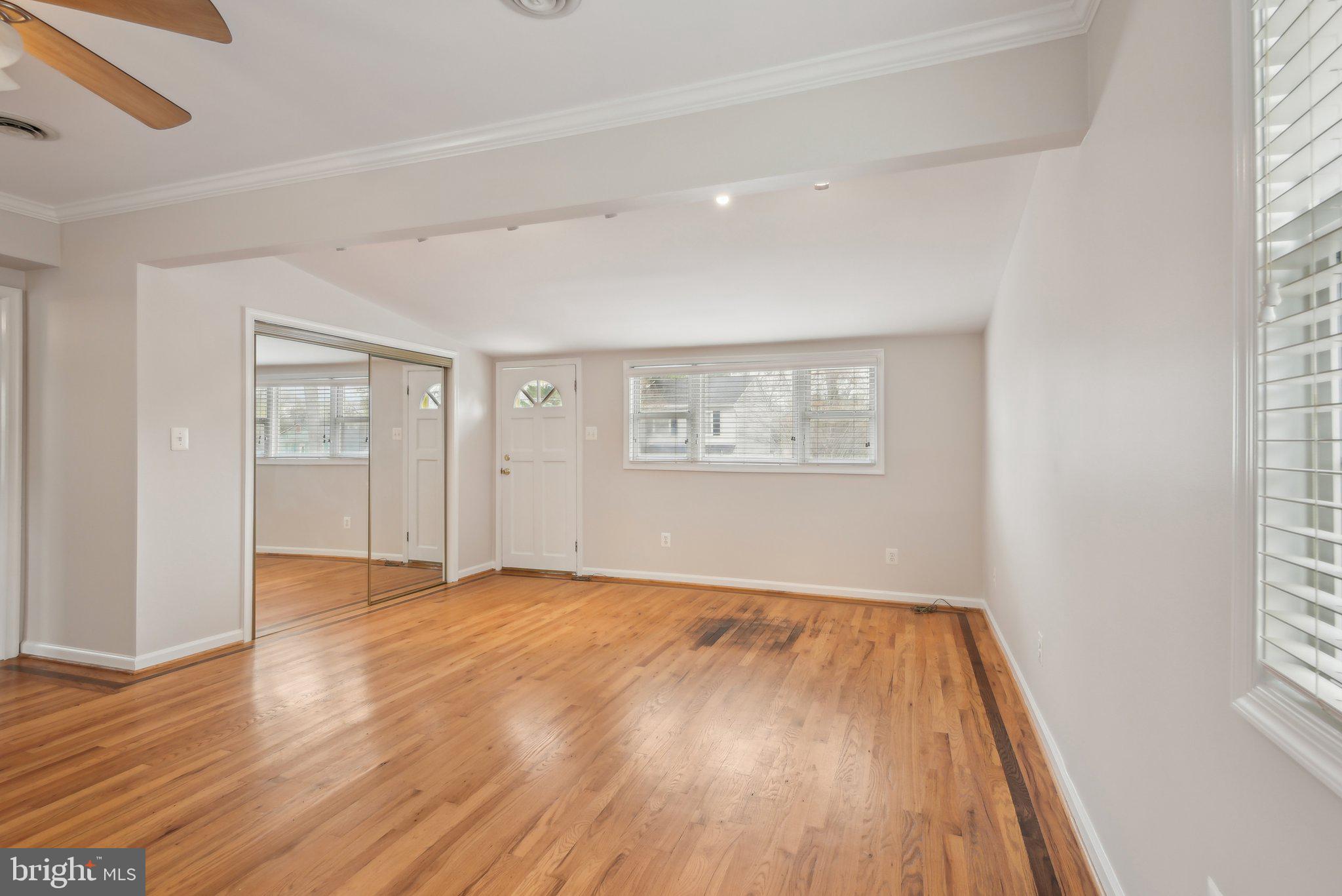 1813 Keymar Road Edgewater, MD 21037 - Photo 4 of 38 a view of an empty room with wooden floor and a window