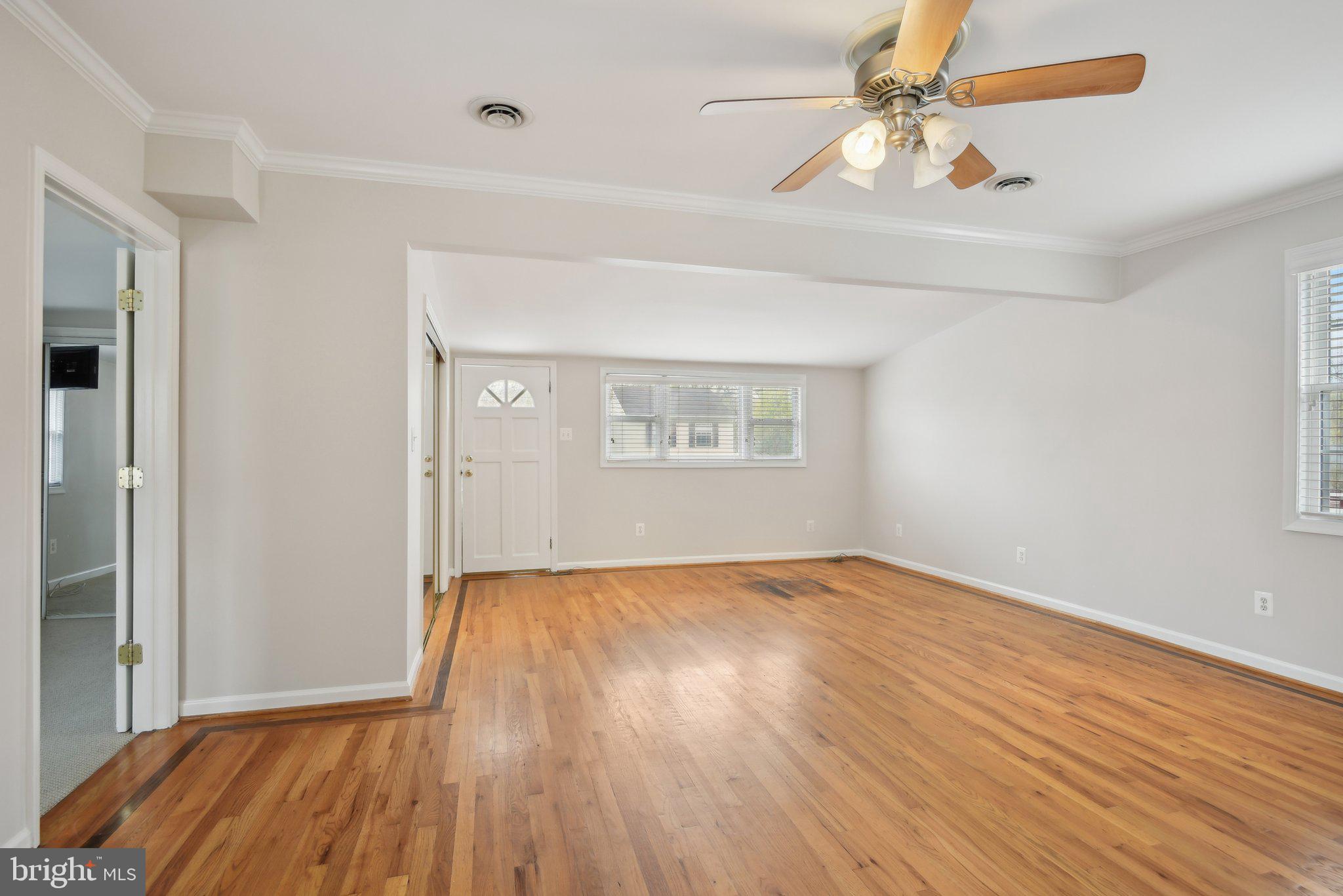 1813 Keymar Road Edgewater, MD 21037 - Photo 6 of 38 wooden floor in an empty room with a window