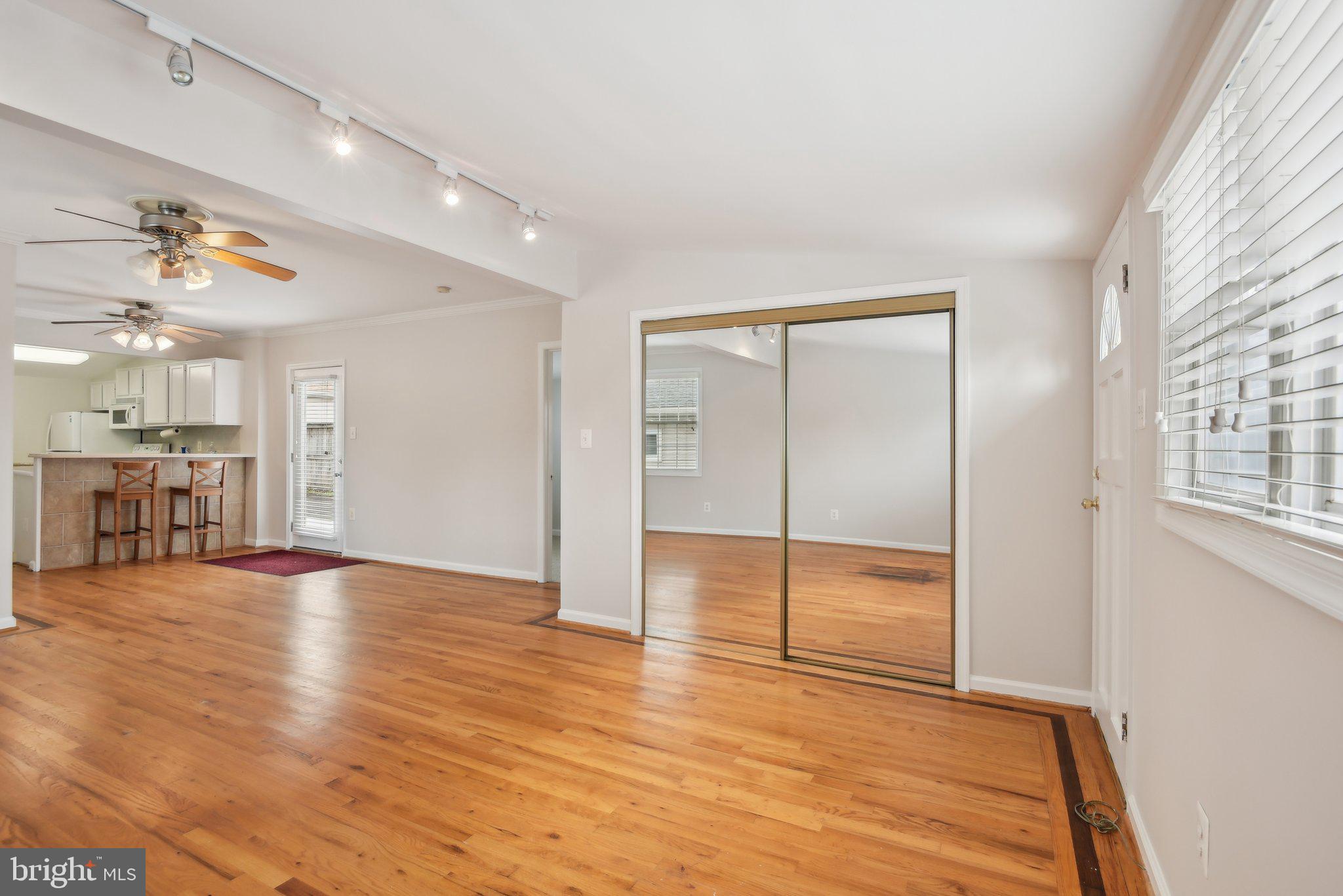 1813 Keymar Road Edgewater, MD 21037 - Photo 7 of 38 a view of an empty room with wooden floor and a window