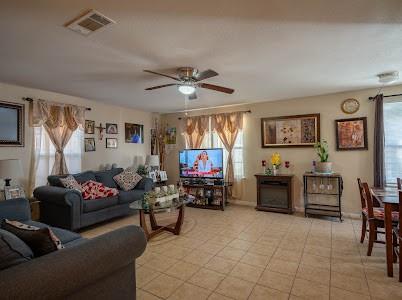 2133 Pleasant Drive Dallas, TX 75227 - Photo 29 of 40 Living area featuring healthy amount of natural light and ceiling fan
