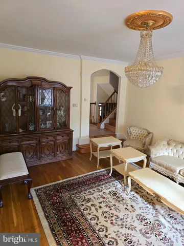 a living room with a rug and a table
