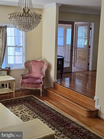 a living room with a couch and a chandelier