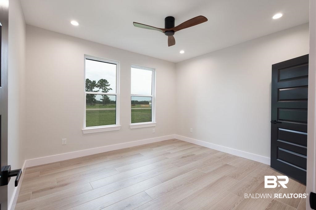 13066 Gopher Court Elberta, AL 36530 - Photo 17 of 38 Neutral wall finishes with wood-finish flooring.