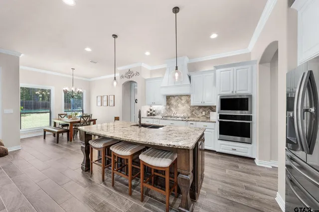 a large kitchen with lots of counter space and furniture