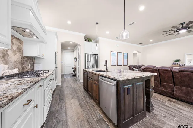 a kitchen with granite countertop a sink and a stove