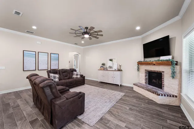 a living room with furniture a flat screen tv and a fireplace