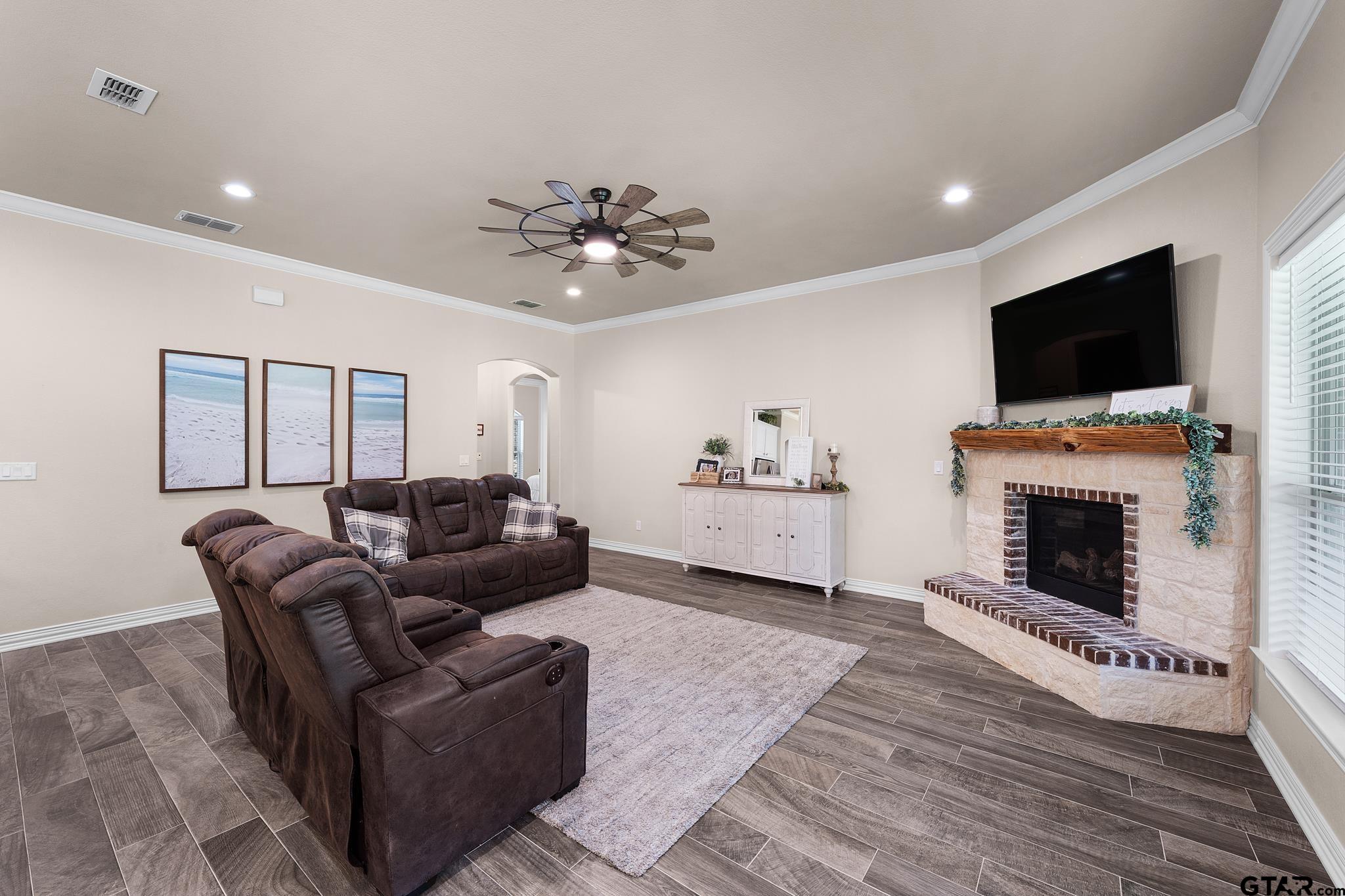 3922 Gable Crest Lane Longview, TX 75605 - Photo 19 of 36 a living room with furniture a flat screen tv and a fireplace