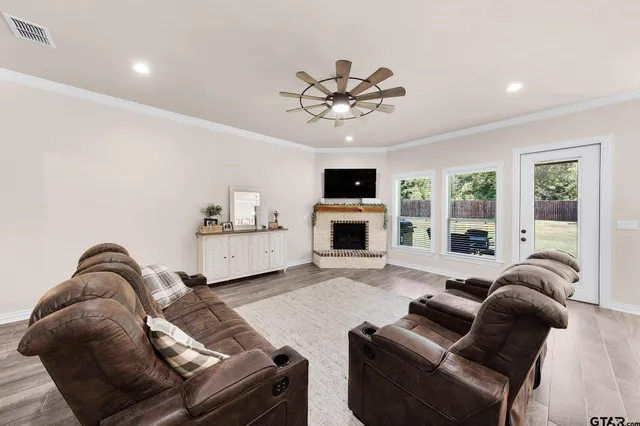 a living room with furniture a fireplace and a flat screen tv