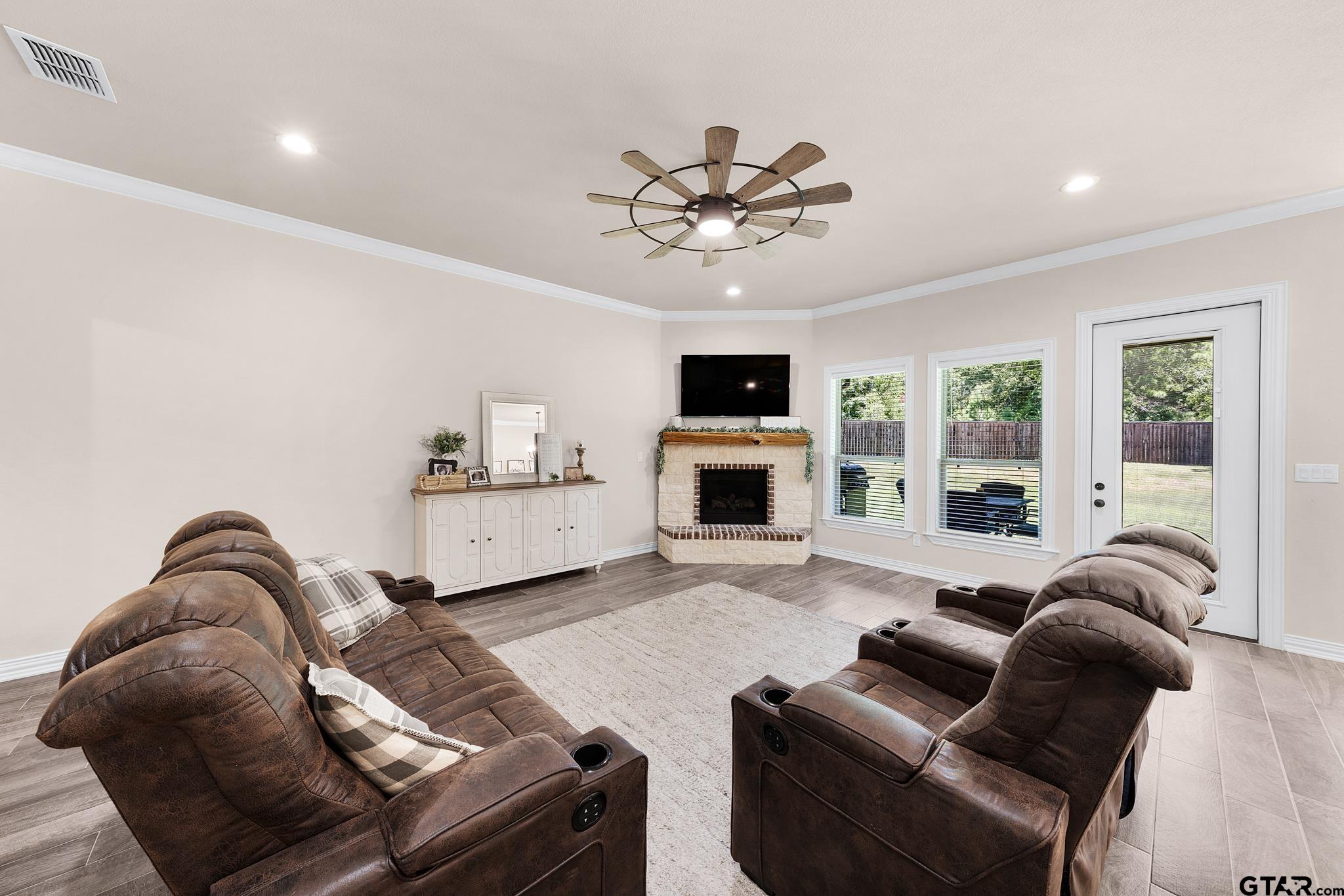 3922 Gable Crest Lane Longview, TX 75605 - Photo 20 of 36 a living room with furniture a fireplace and a flat screen tv
