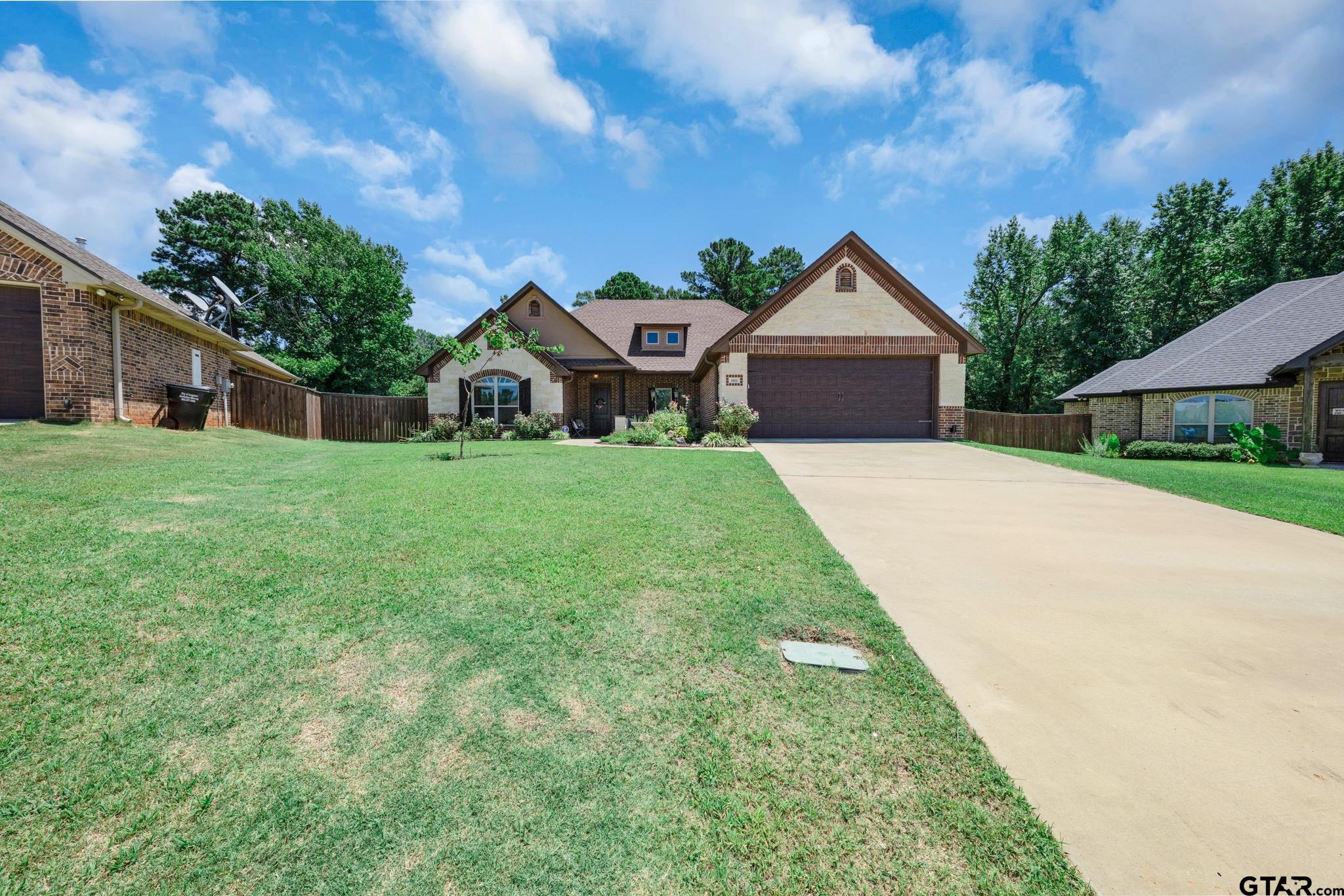 3922 Gable Crest Lane Longview, TX 75605 - Photo 2 of 36 a front view of a house with a yard and garage