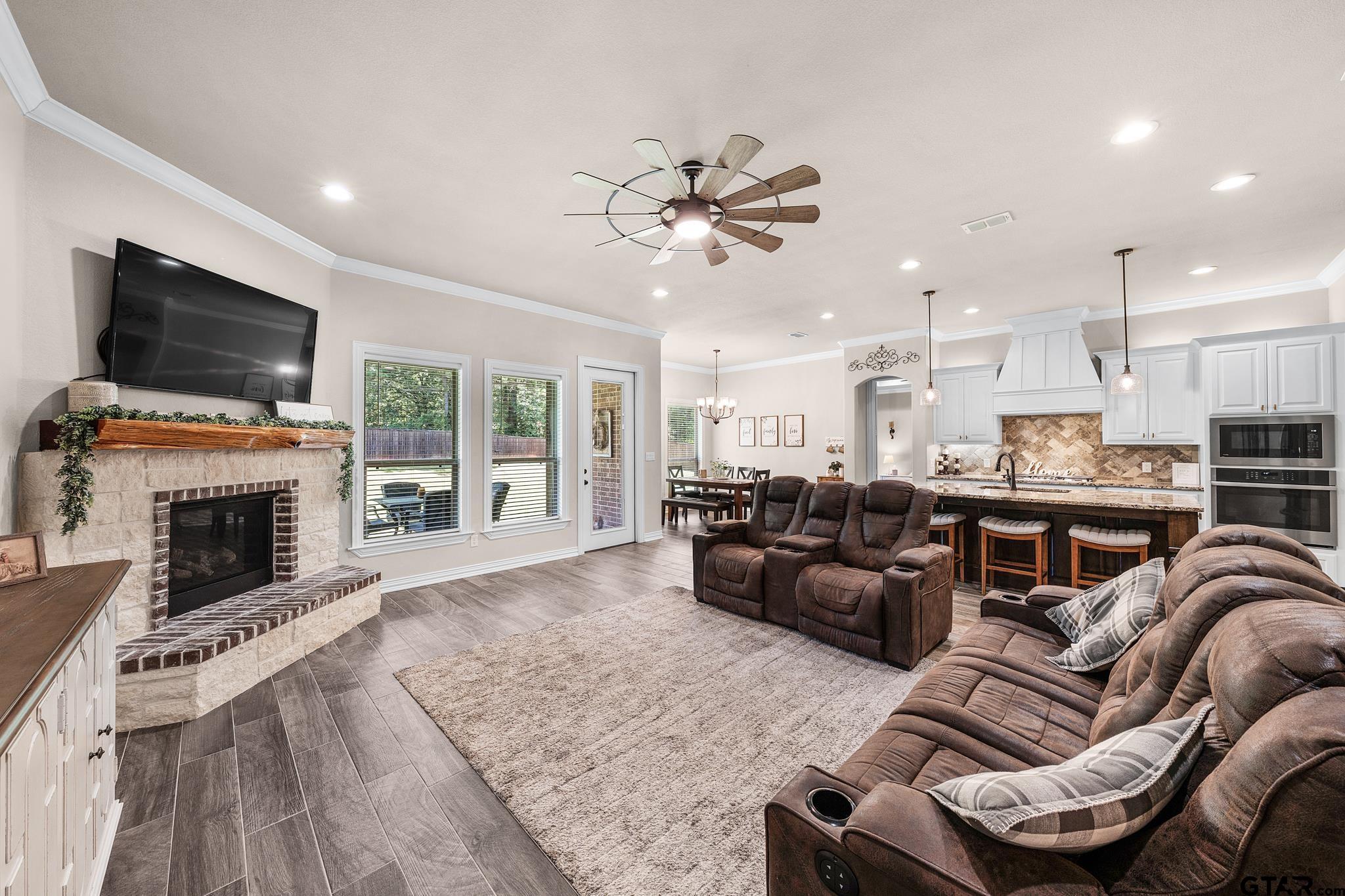 3922 Gable Crest Lane Longview, TX 75605 - Photo 21 of 36 a living room with furniture a flat screen tv and a fireplace