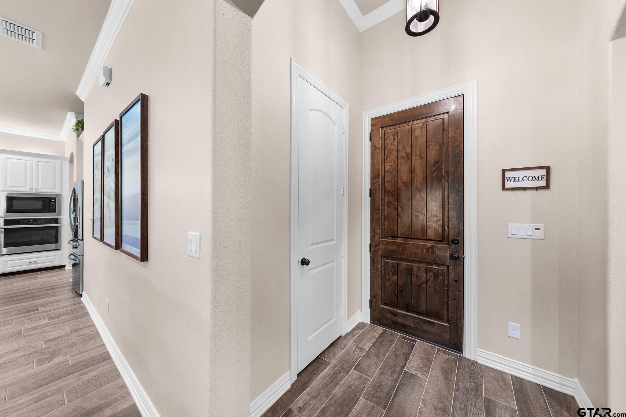 3922 Gable Crest Lane Longview, TX 75605 - Photo 22 of 36 a view of a hallway with wooden floor and staircase