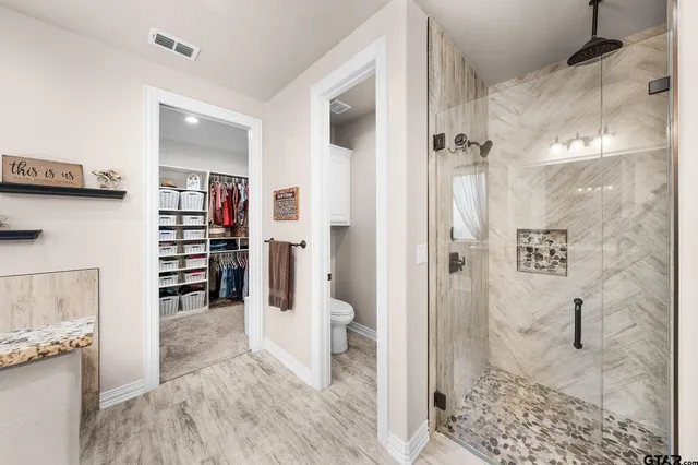 a view of a bathroom with a tub and shower