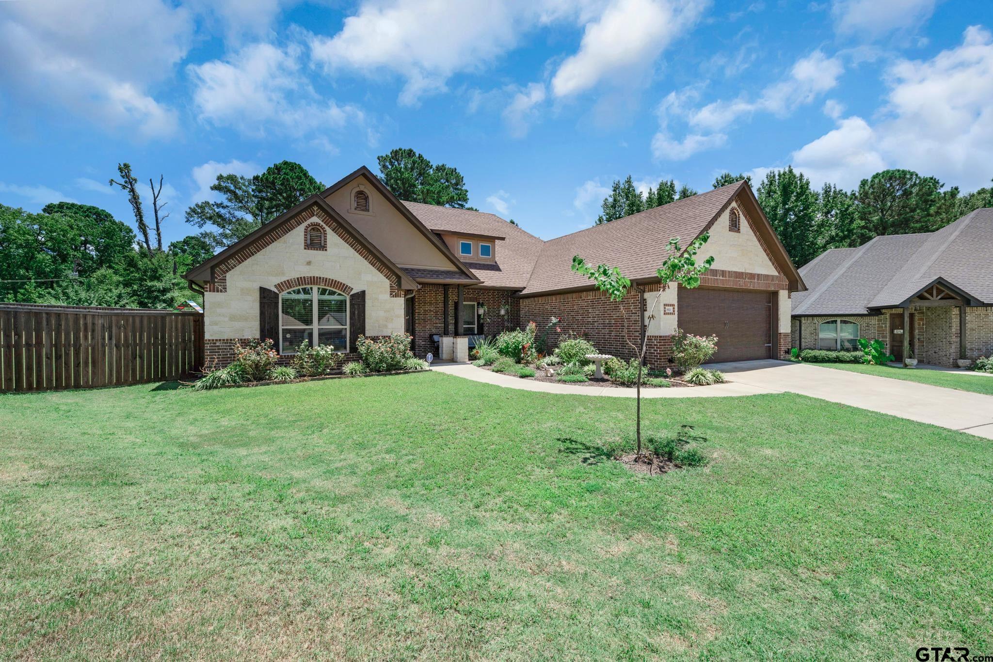 3922 Gable Crest Lane Longview, TX 75605 - Photo 3 of 36 a front view of a house with a yard and green space