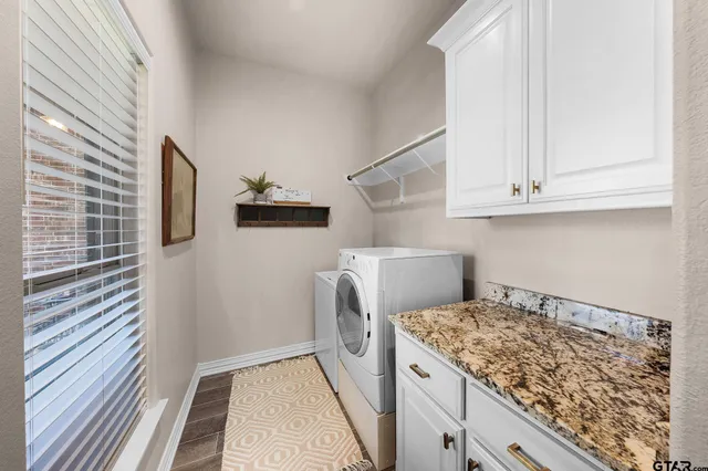 a view of a storage and utility room with washer and dryer