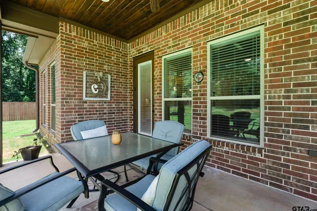 a view of a deck with table and chairs with wooden floor and fence